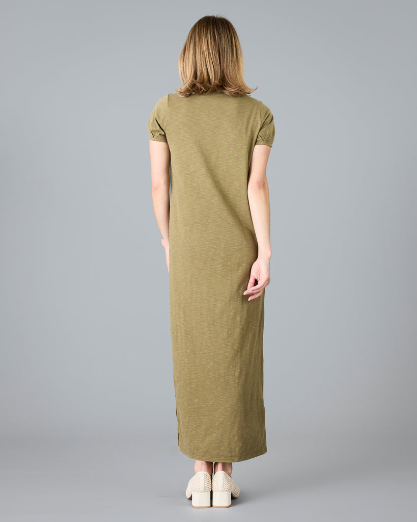 Woman in a short sleeve olive green sheath dress