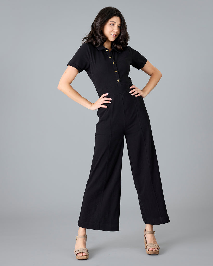 Woman in a black, short sleeve jumpsuit