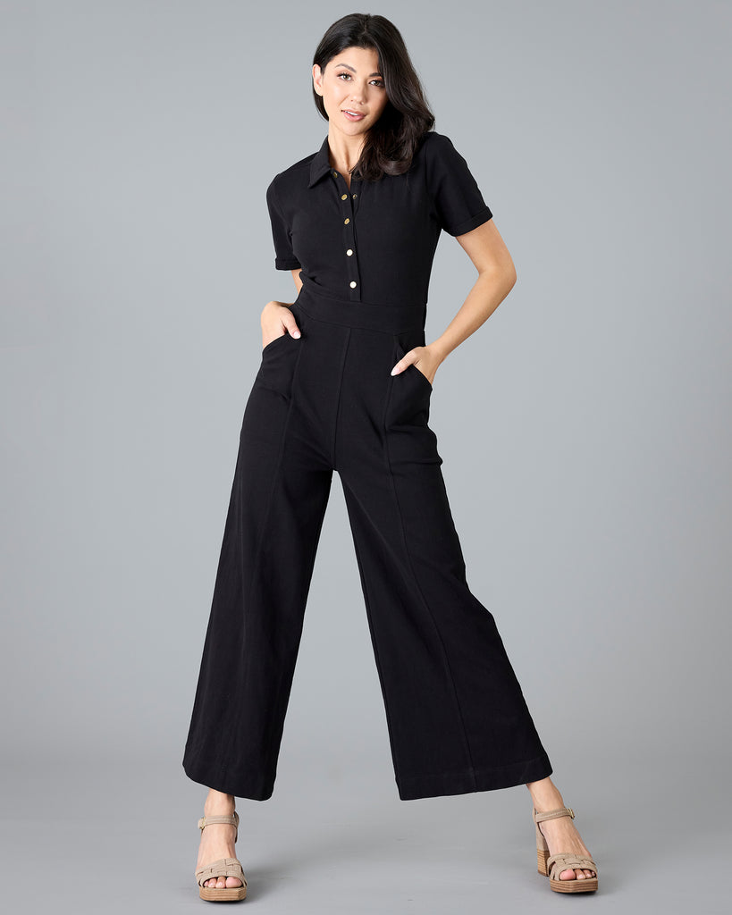 Woman in a black, short sleeve jumpsuit