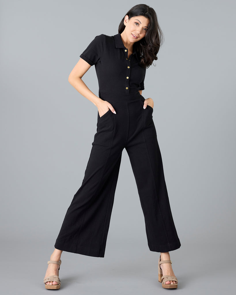 Woman in a black, short sleeve jumpsuit