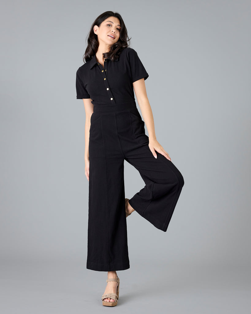 Woman in a black, short sleeve jumpsuit