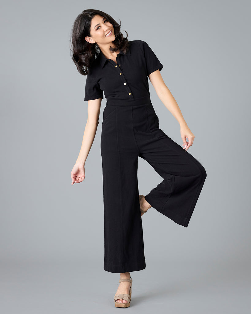 Woman in a black, short sleeve jumpsuit