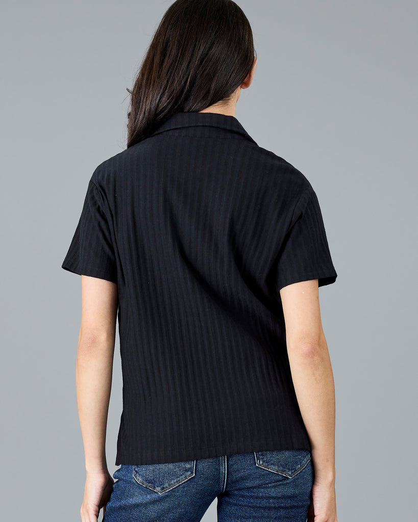 Woman in a black short sleeve polo