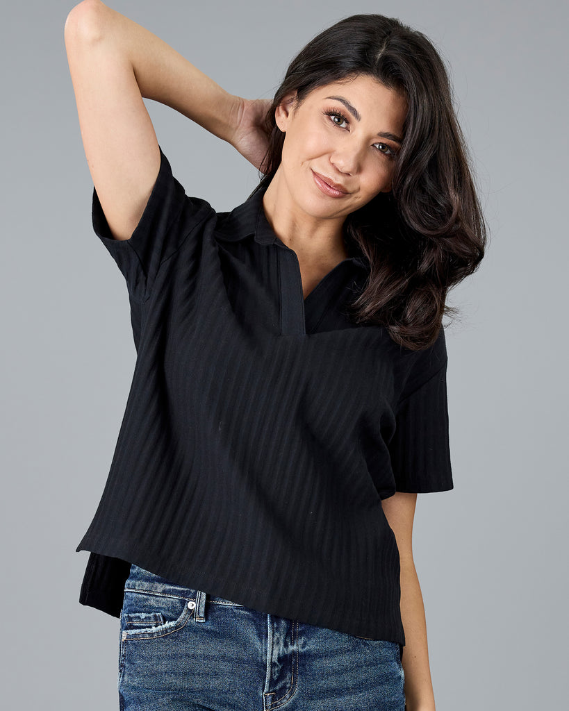 Woman in a black short sleeve polo