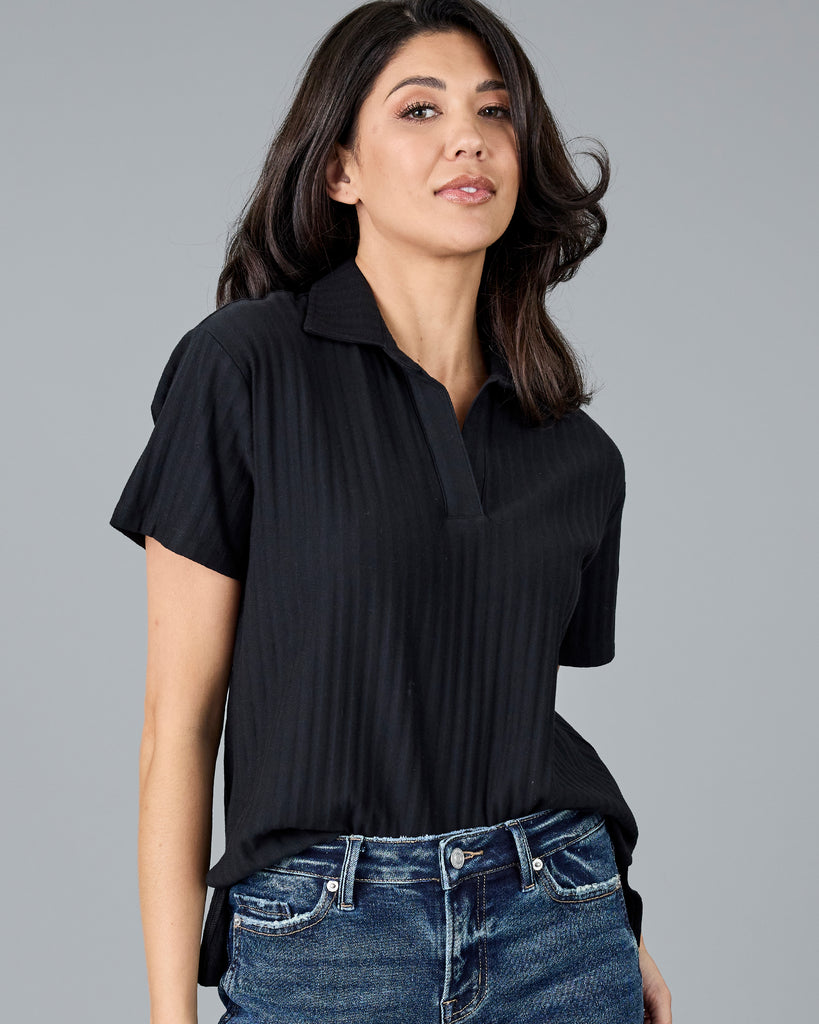 Woman in a black short sleeve polo