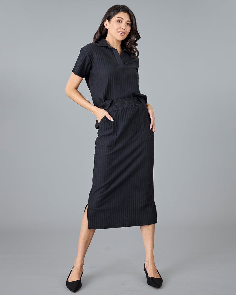 Woman in a black ribbed midi skirt