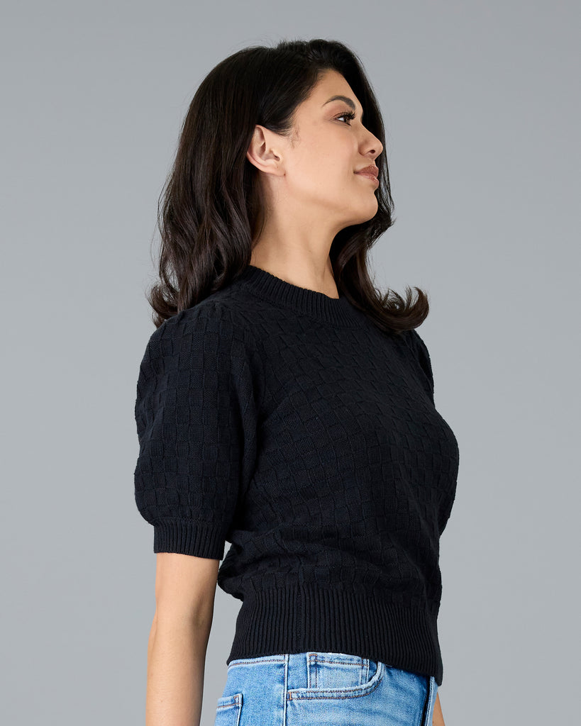 Woman in a short sleeve black sweater