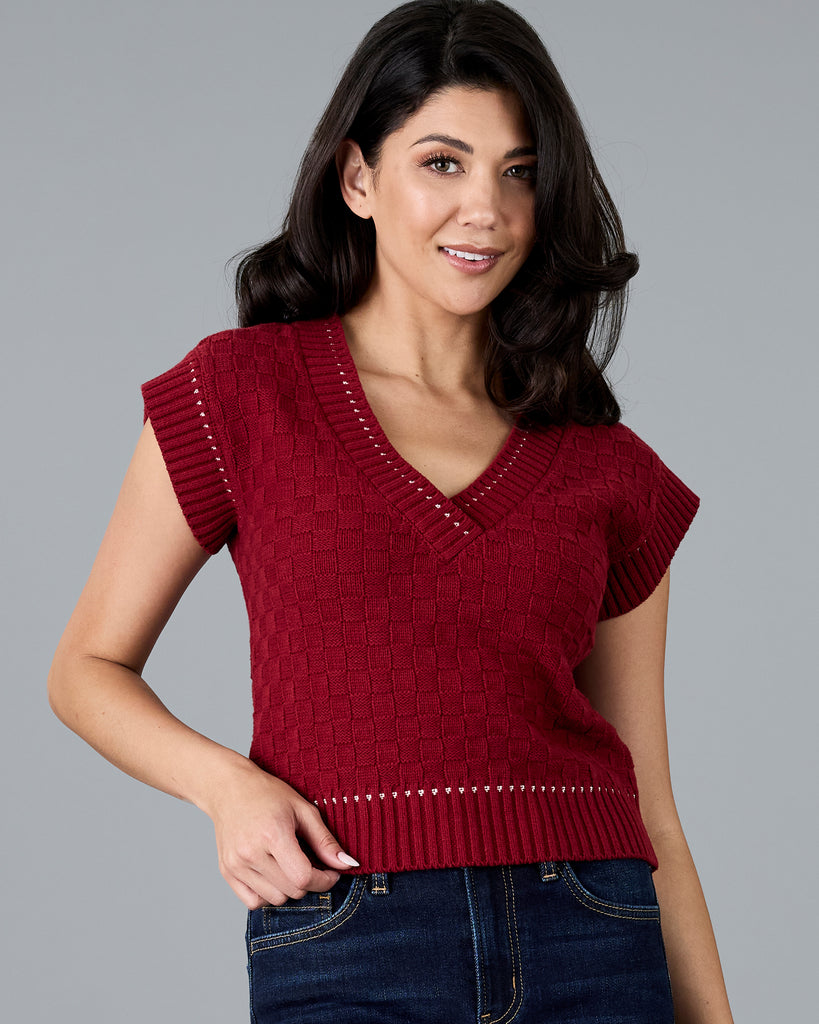 Woman in a red knit vest