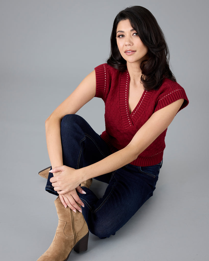 Woman in a red knit vest