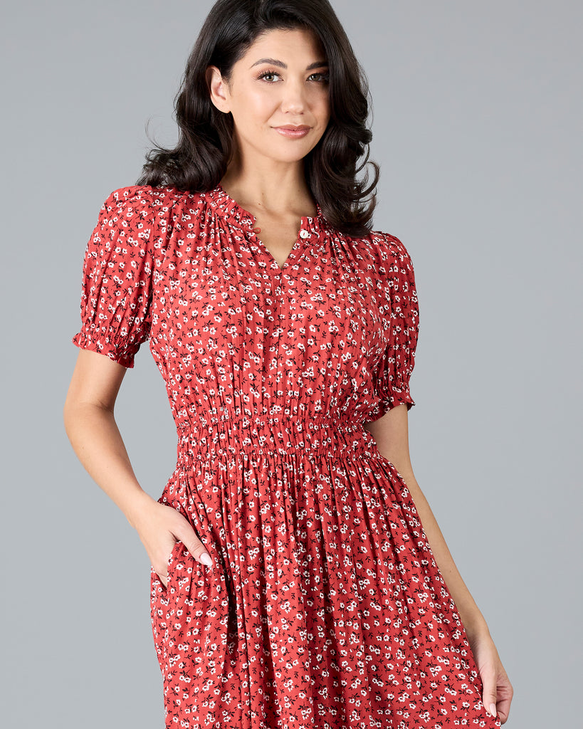 Woman in a red floral print short sleeve midi dress