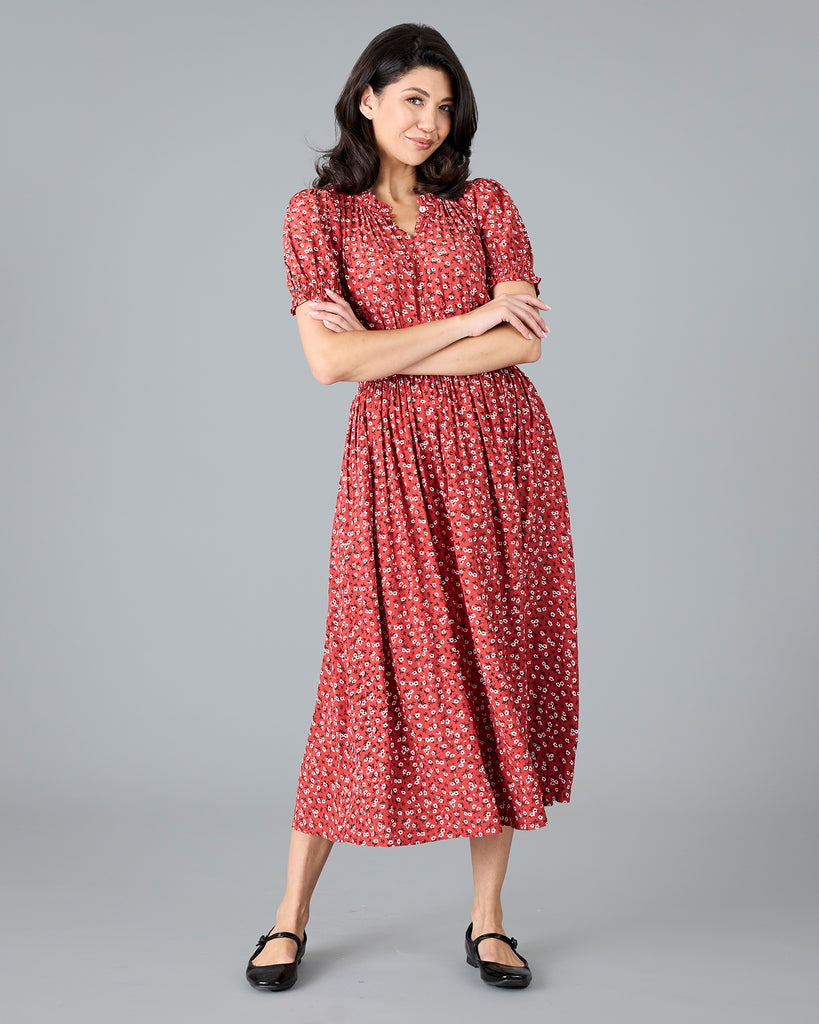 Woman in a red floral print short sleeve midi dress