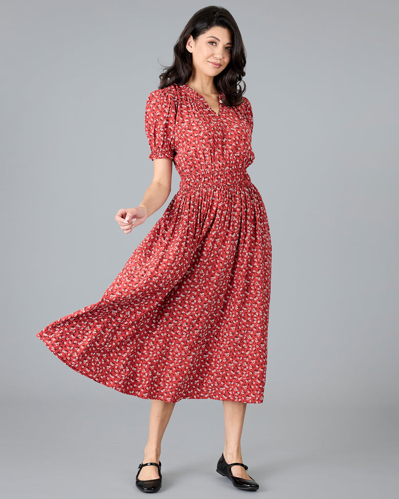 Woman in a red floral print short sleeve midi dress