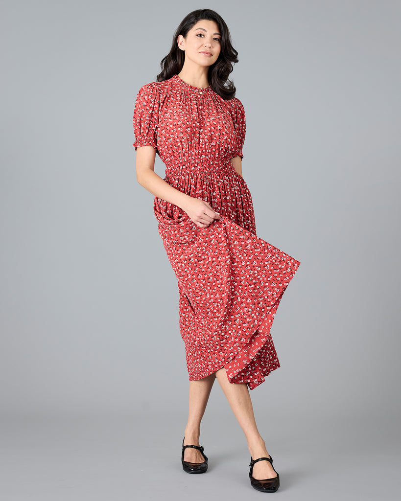 Woman in a red floral print short sleeve midi dress