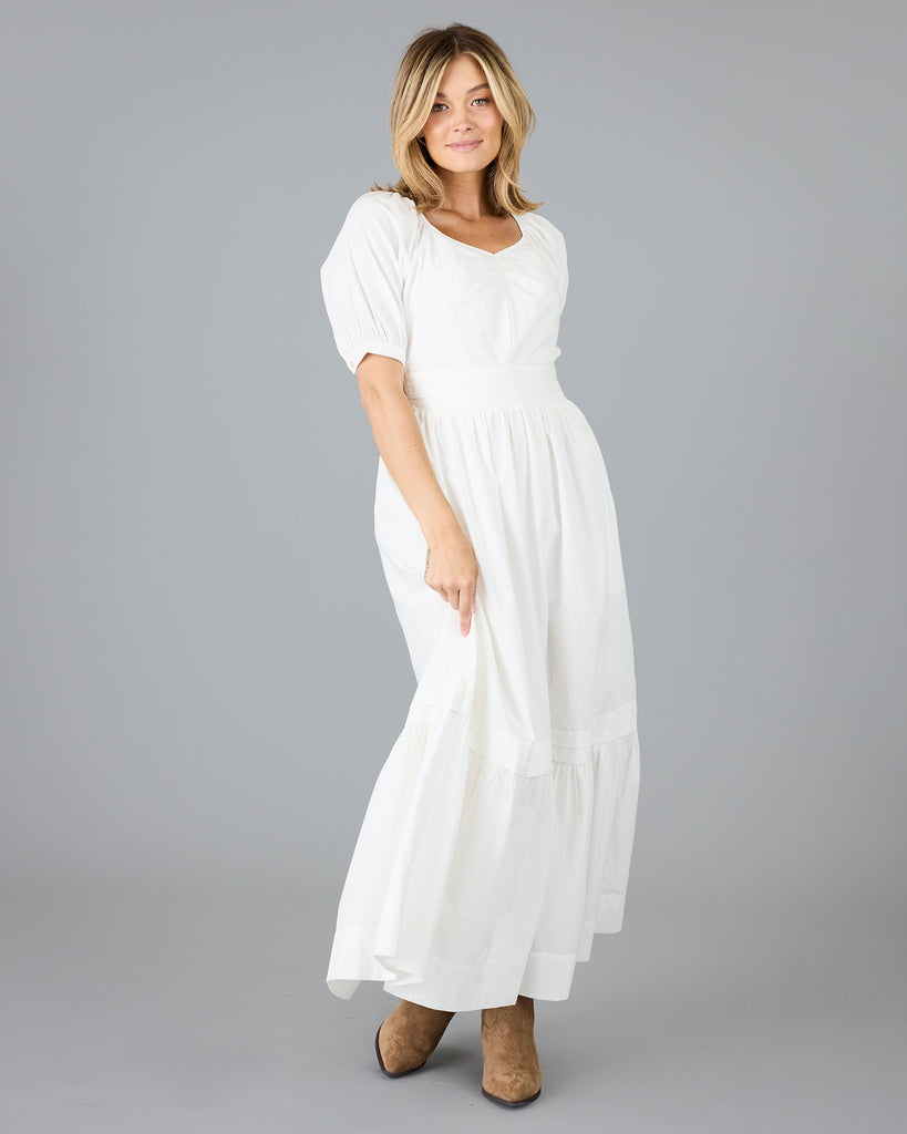 Woman in a white short sleeve v-neck dress