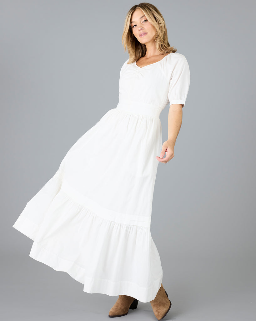 Woman in a white short sleeve v-neck dress