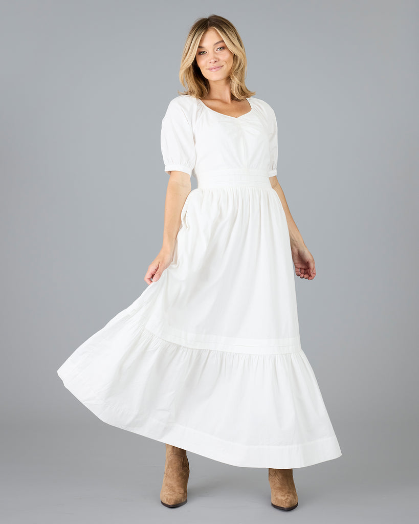 Woman in a white short sleeve v-neck dress