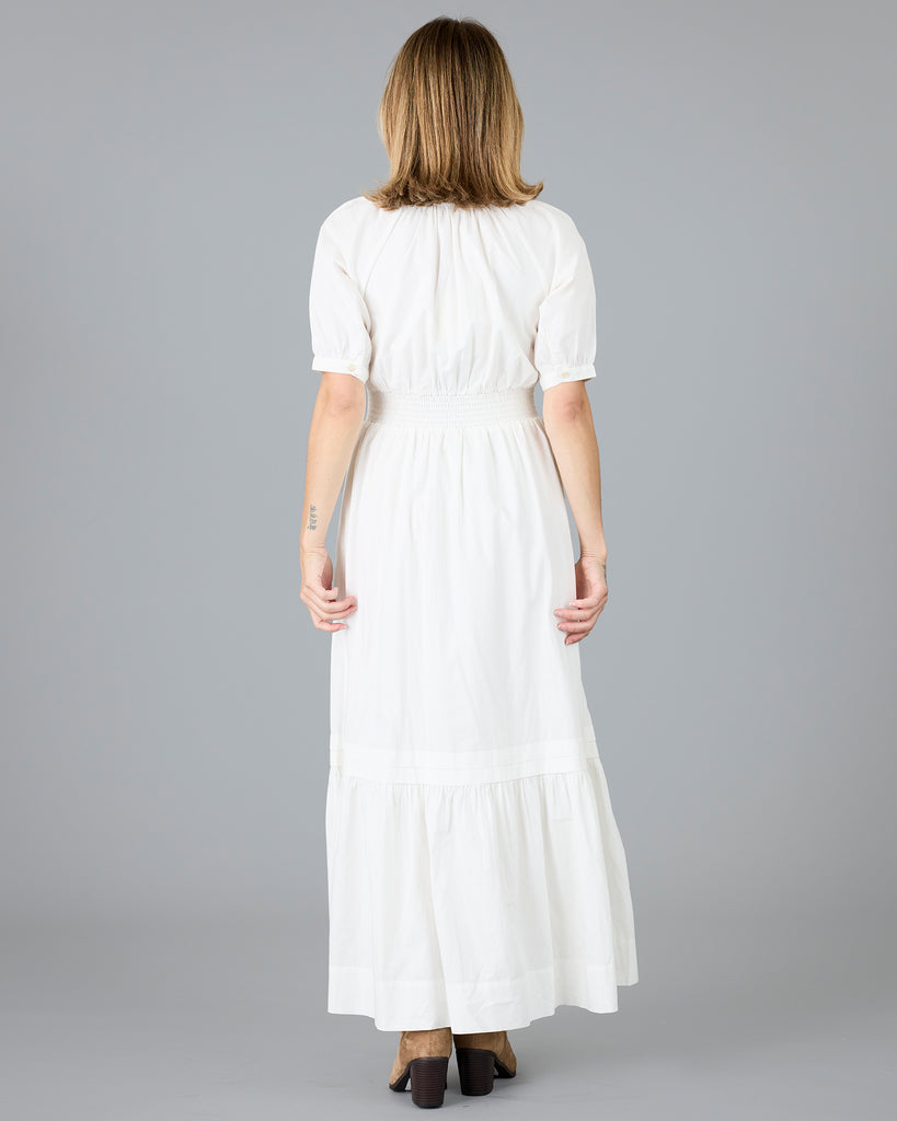 Woman in a white short sleeve v-neck dress