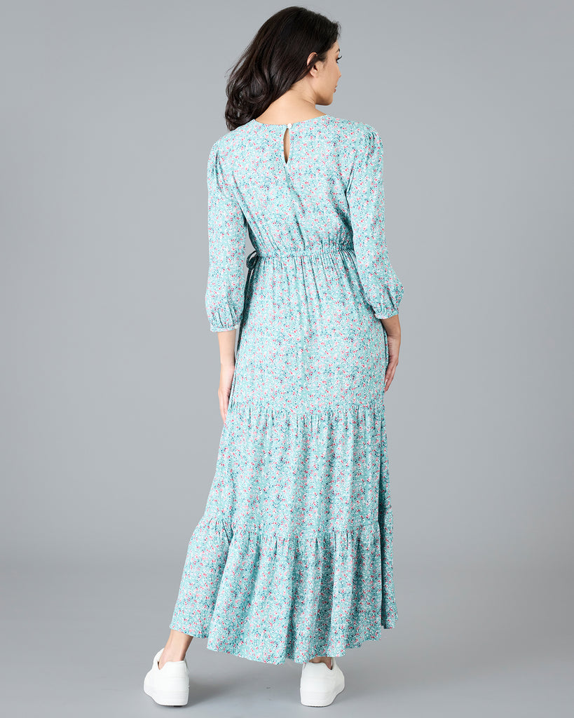 Woman in a blue floral print, long sleeve maxi dress