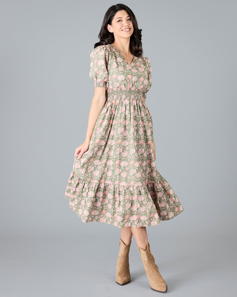 Woman in a green and pink paisley print, short sleeve midi dress