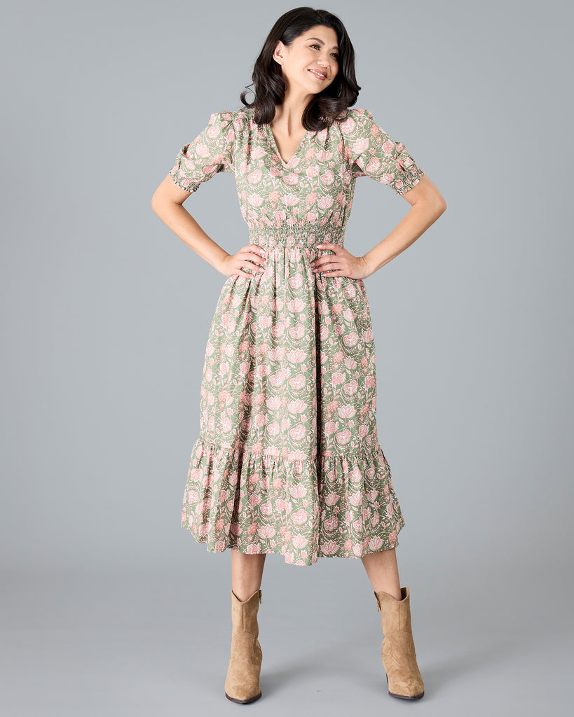 Woman in a green and pink paisley print, short sleeve midi dress