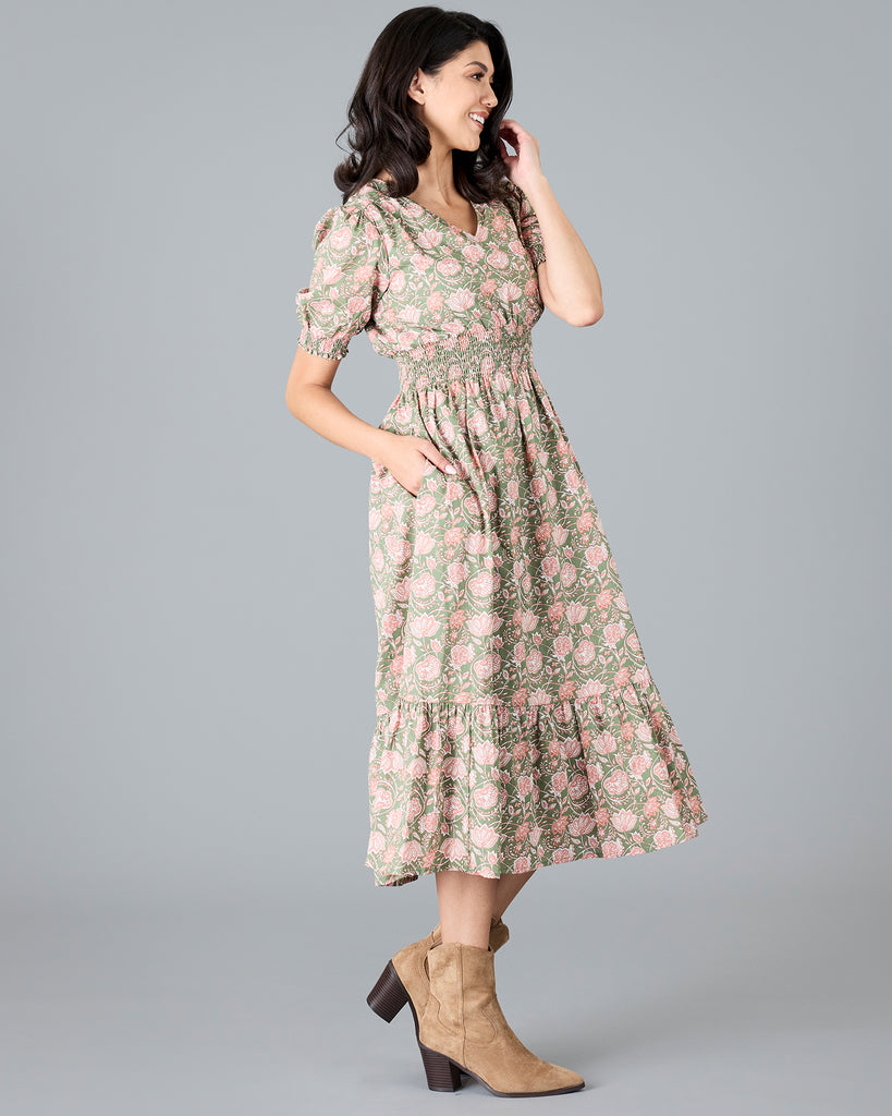 Woman in a green and pink paisley print, short sleeve midi dress