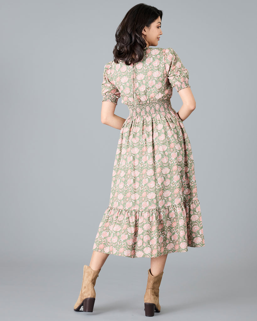 Woman in a green and pink paisley print, short sleeve midi dress