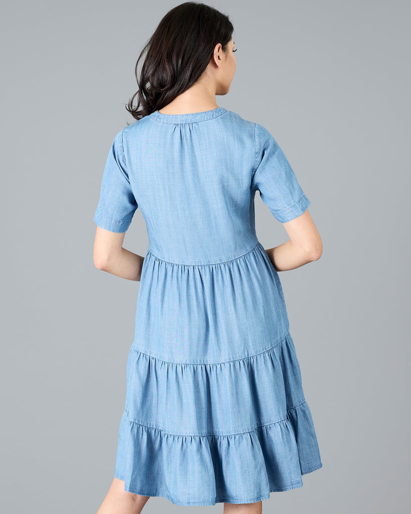 Woman in a short sleeve, knee-length chambray dress