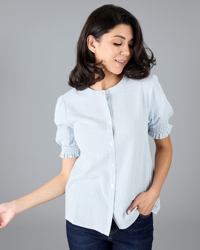 Woman in a short sleeve gingham print buttondown blouse