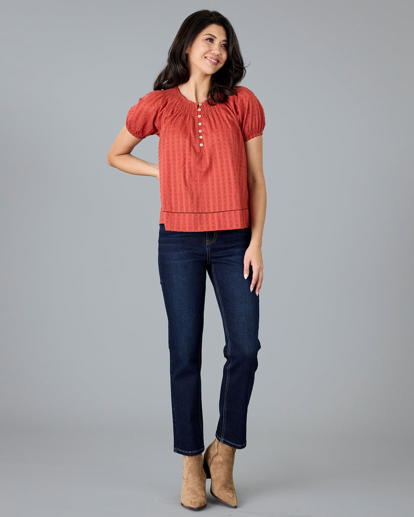 Woman in a short sleeve orange blouse