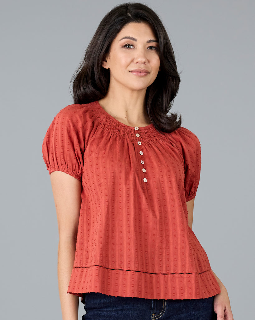 Woman in a short sleeve orange blouse