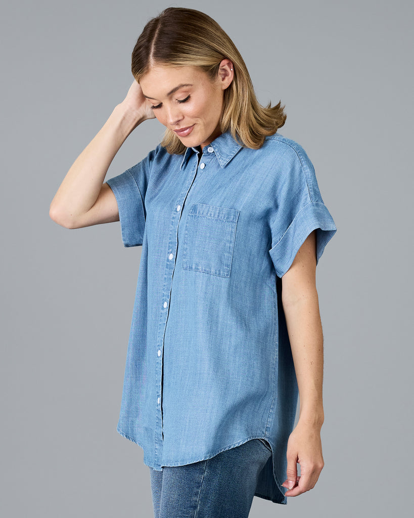 Woman in a short sleeve buttondown chambray top