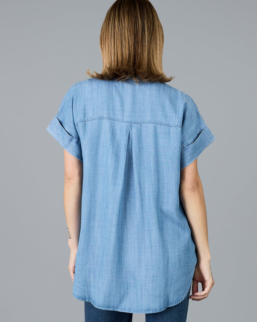 Woman in a short sleeve buttondown chambray top