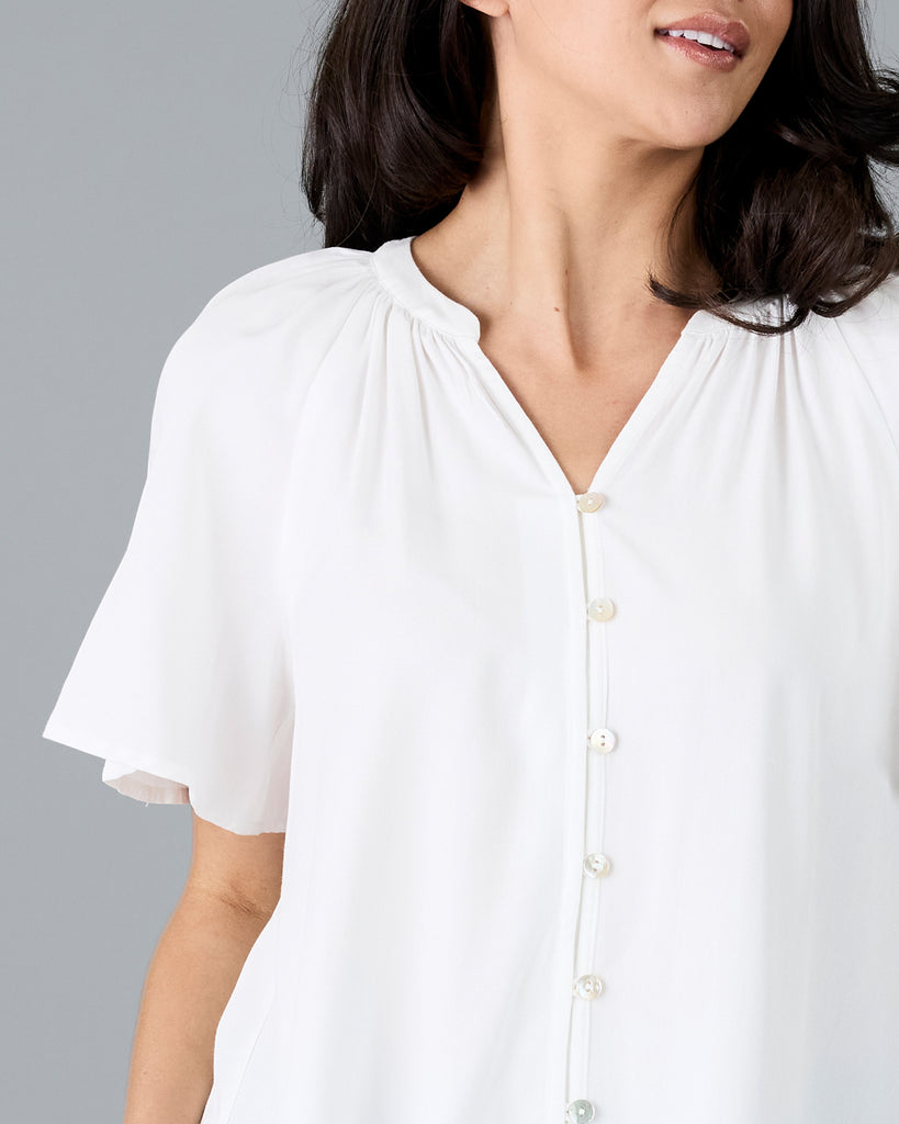 Woman in a short sleeve v-neck white blouse