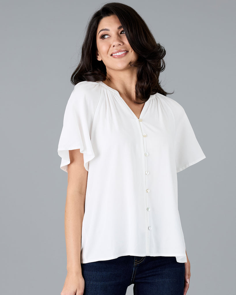 Woman in a short sleeve v-neck white blouse