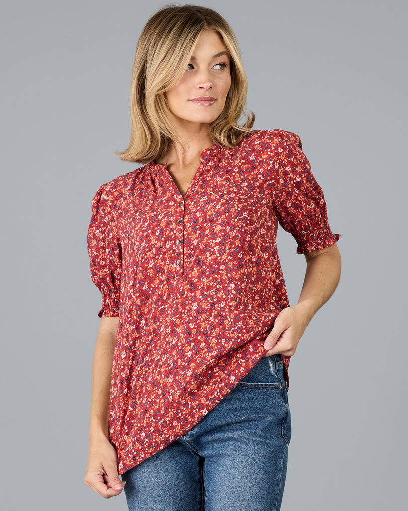 Woman in a red floral print short sleeve blouse