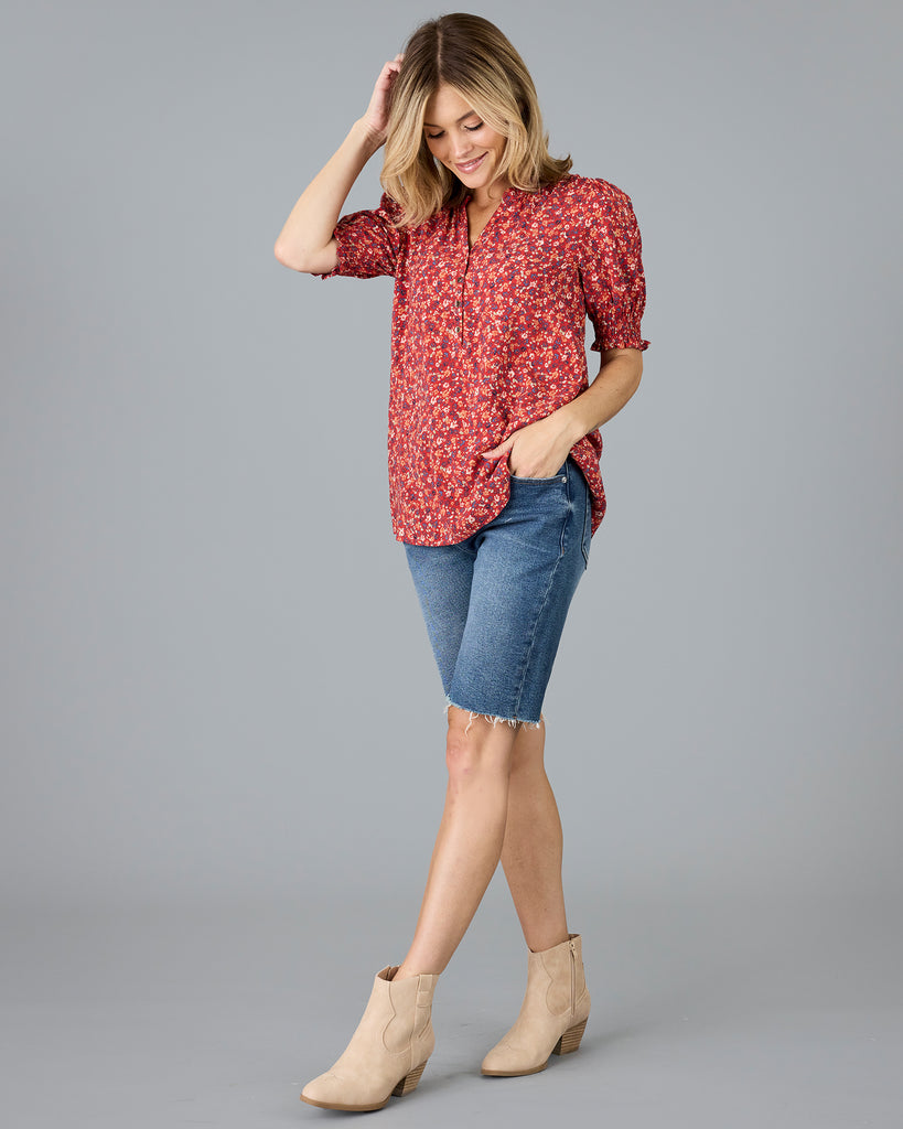 Woman in a red floral print short sleeve blouse