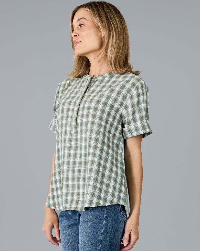 Woman in a plaid green short sleeve blouse