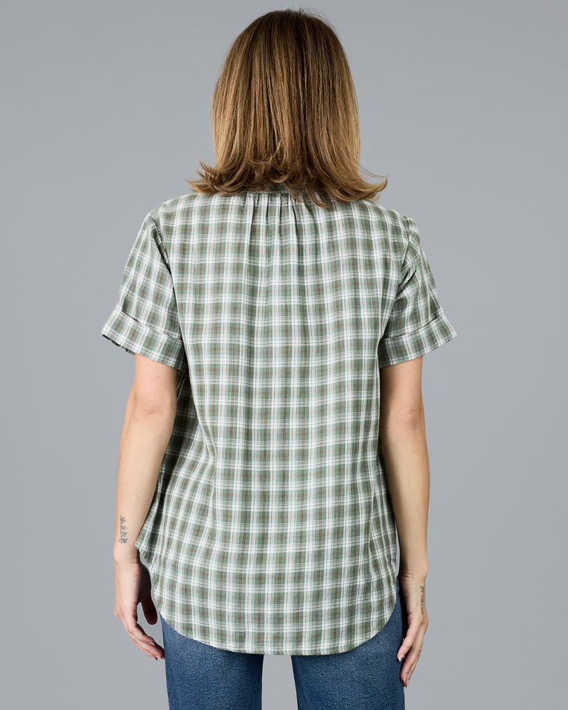 Woman in a plaid green short sleeve blouse