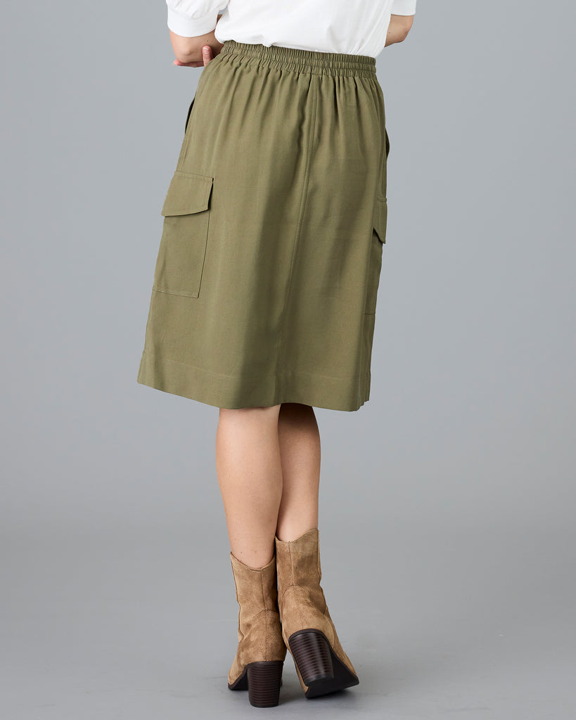 Woman in an olive green, knee length skirt