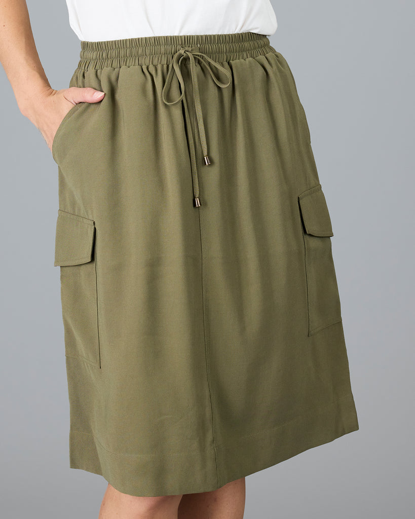 Woman in an olive green, knee length skirt