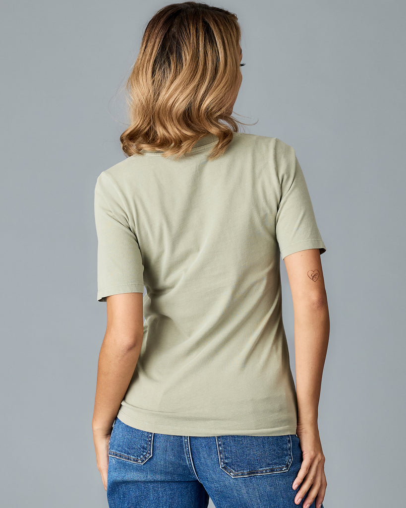 Woman in a green, short sleeved v-neck tshirt