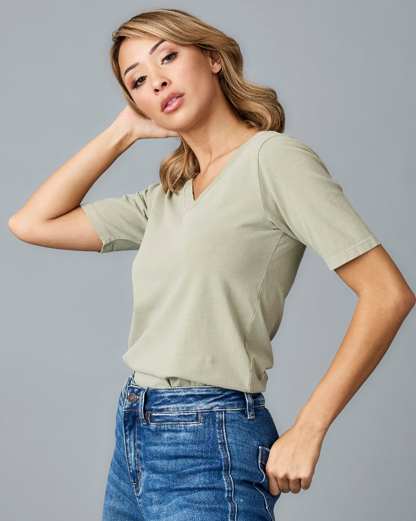 Woman in a green, short sleeved v-neck tshirt