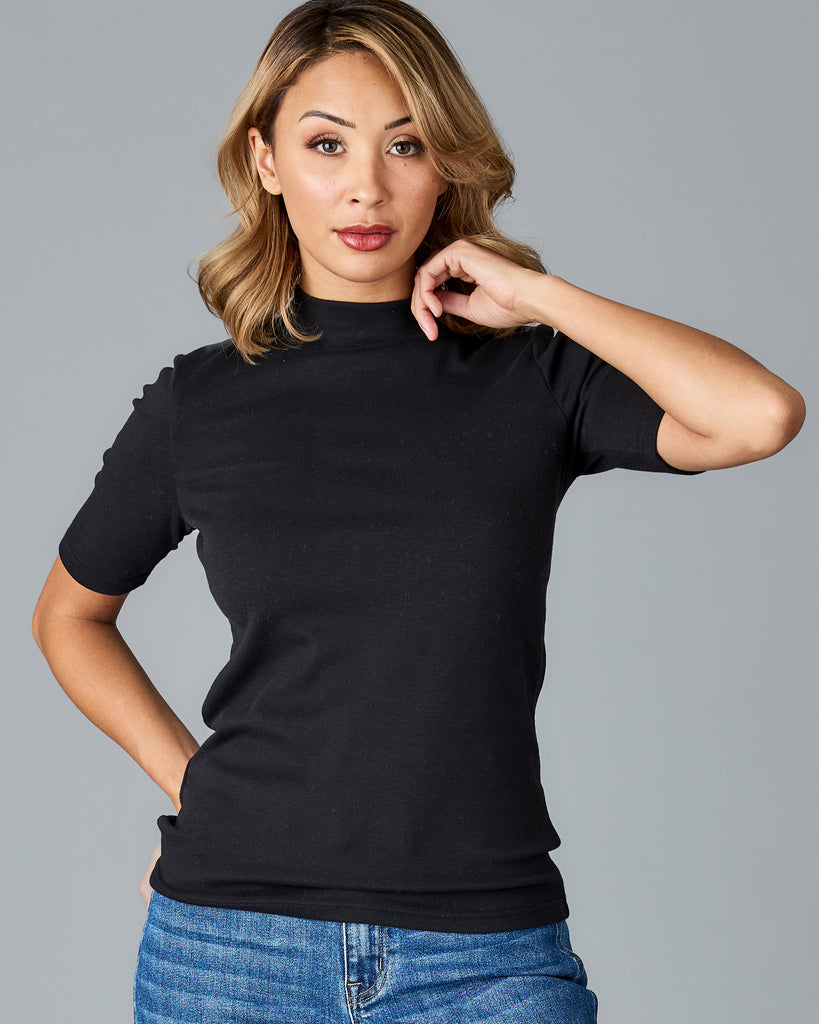 Woman in a black, half sleeved mock neck top