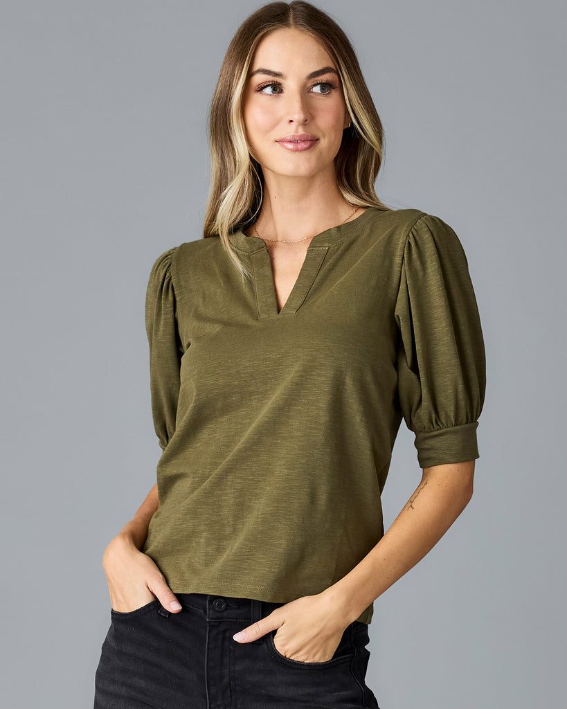 Woman in a green, short sleeved v-neck tshirt