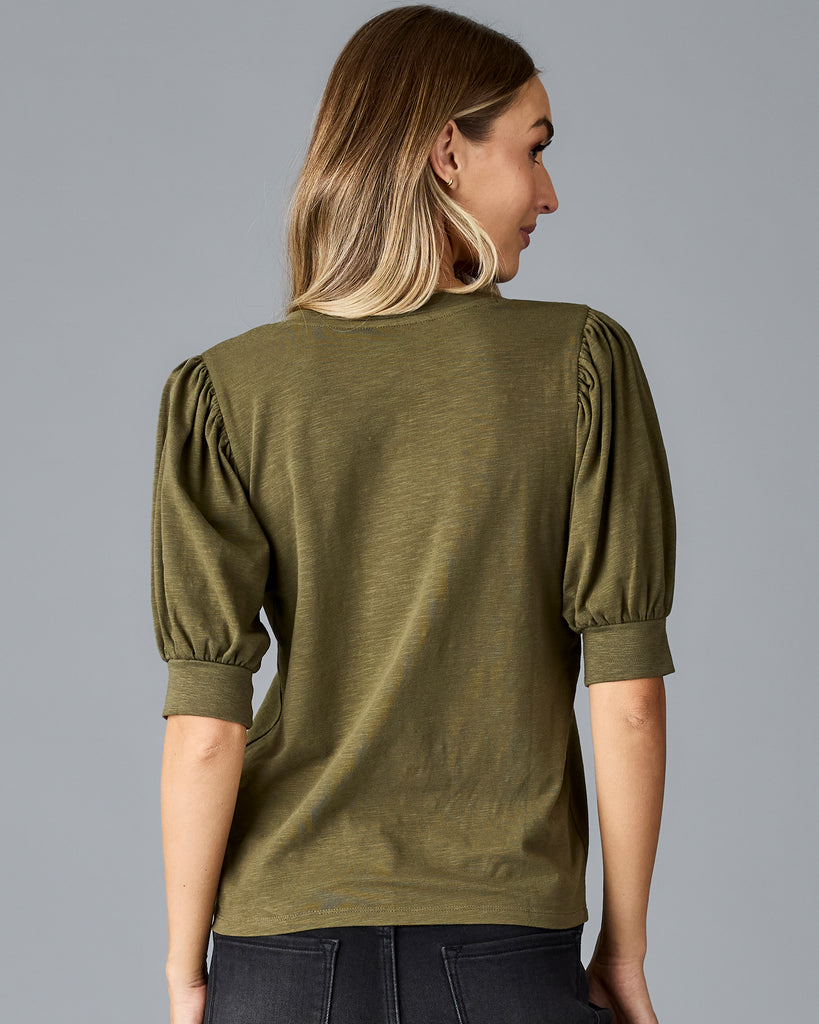 Woman in a green, short sleeved v-neck tshirt