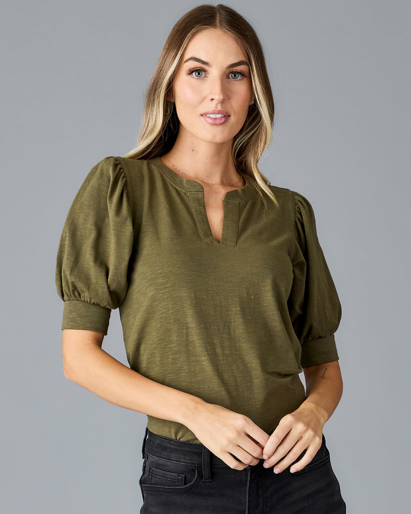 Woman in a green, short sleeved v-neck tshirt