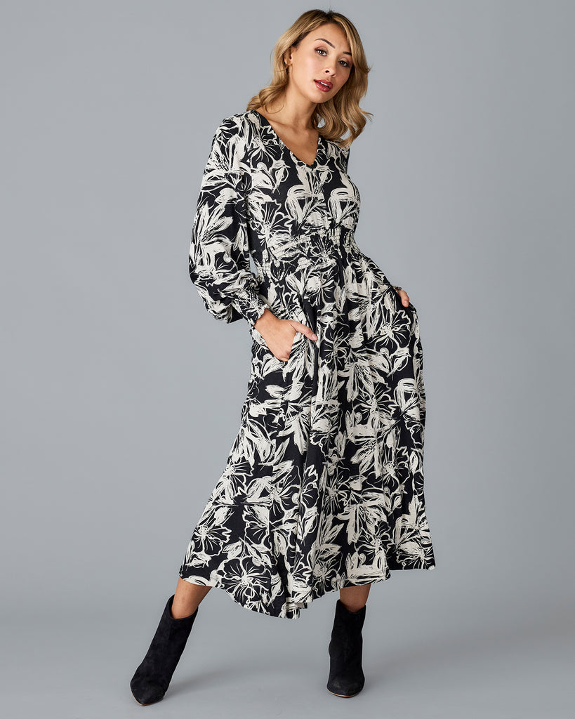 Woman in a black and white floral print midi dress