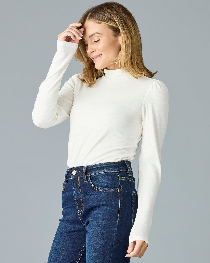 Woman in a white, long sleeve, mock neck basic tee