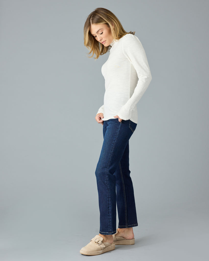 Woman in a white, long sleeve, mock neck basic tee