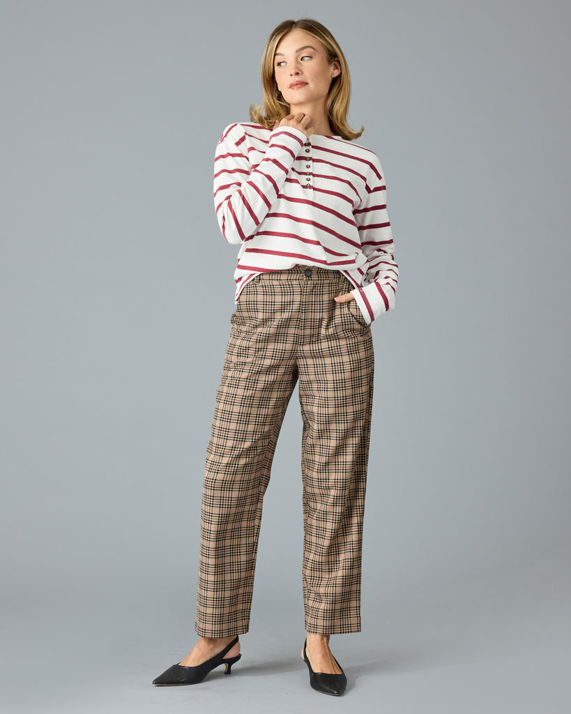 Woman in tan and red plaid trousers